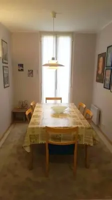 a dining room with a table and chairs and a window at Casa Charlotte nel cuore di Cannes in Cannes