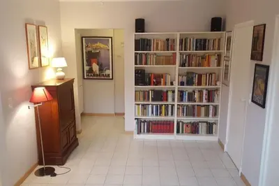 a living room with two book shelves filled with books at Casa Charlotte nel cuore di Cannes in Cannes