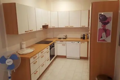 a kitchen with white cabinets and a stove top oven at Casa Charlotte nel cuore di Cannes in Cannes