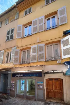 a building with white shuttered windows and a store at Charmant 2 chambres, MEYNADIER- FORVILE A2B243 in Cannes