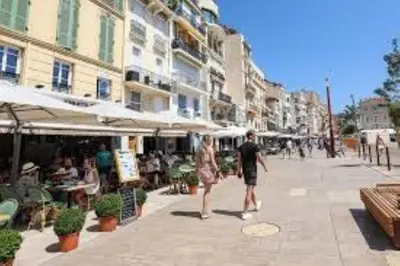 a man and a woman walking down a city street at Charmant 2 chambres, MEYNADIER- FORVILE A2B243 in Cannes