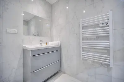 a white bathroom with a sink and a mirror at Charmant 2 chambres, MEYNADIER- FORVILE A2B243 in Cannes