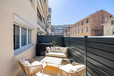 a balcony with chairs and a table on a building at Luxurious Apartment- Croisette-Carré d'Or in Cannes