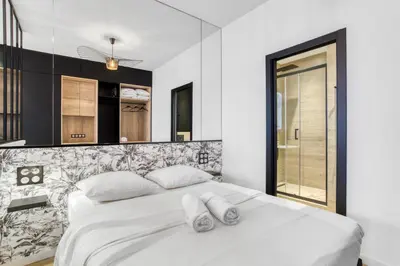 a bedroom with a white bed and a mirror at 1 Chambre Modern D - Calme - Hypercentre à 2 minutes du palais in Cannes