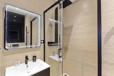 a bathroom with a sink and a mirror at 1 Chambre Modern D - Calme - Hypercentre à 2 minutes du palais in Cannes