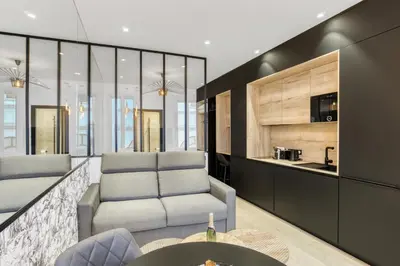 a living room with two chairs and a table at 1 Chambre Modern D - Calme - Hypercentre à 2 minutes du palais in Cannes