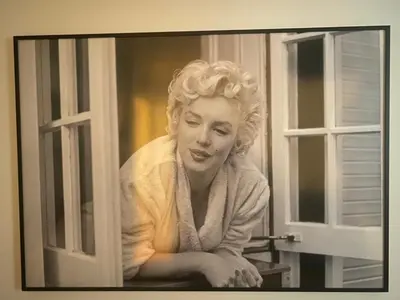 a painting of a woman looking out of a window at Très Bel Appartement Palais Festivals Plage Croisette Suquet in Cannes