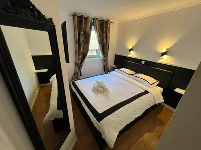 a bedroom with a bed with a teddy bear on it at Très Bel Appartement Palais Festivals Plage Croisette Suquet in Cannes