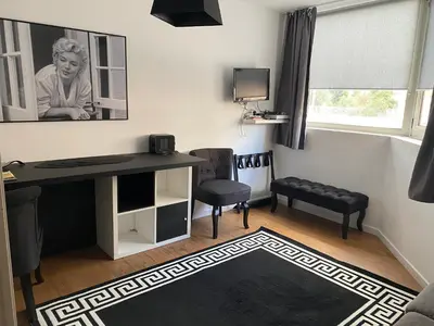 a living room with a desk and a chair at Très Bel Appartement Palais Festivals Plage Croisette Suquet in Cannes