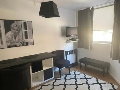 a small living room with a desk and a chair at Très Bel Appartement Palais Festivals Plage Croisette Suquet in Cannes