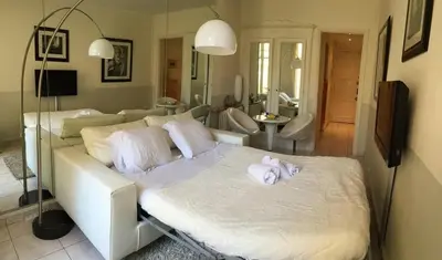 a bedroom with a white bed with towels on it at Cannes Croisette - PALAIS MIRAMAR - Studio au calme avec terrasse in Cannes