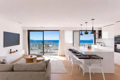 a kitchen and living room with a view of the ocean at Suite Horizon Penthouse d'exception avec Vue Mer à Cannes in Cannes