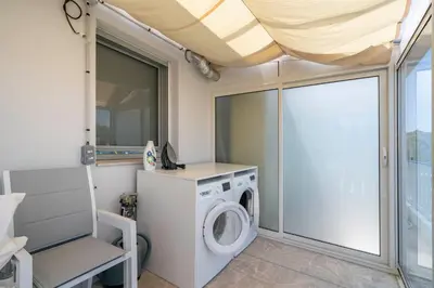 a laundry room with a washer and dryer at Suite Horizon Penthouse d'exception avec Vue Mer à Cannes in Cannes