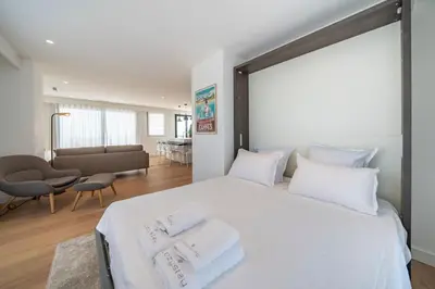 a bedroom with a large white bed with towels on it at Suite Horizon Penthouse d'exception avec Vue Mer à Cannes in Cannes