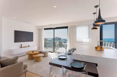 a kitchen and living room with a view of the ocean at Suite Horizon Penthouse d'exception avec Vue Mer à Cannes in Cannes