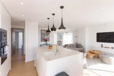 a kitchen and living room with a white counter top at Suite Horizon Penthouse d'exception avec Vue Mer à Cannes in Cannes