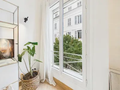 a room with a window and a plant at Appartement centre cannes croisette / palais festival in Cannes