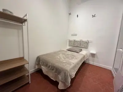a small bedroom with a bed in a room at Appartement central rue Hoche in Cannes