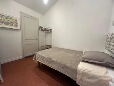 a bedroom with a bed and a white door at Appartement central rue Hoche in Cannes