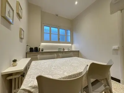 a kitchen and dining room with a table and chairs at Appartement central rue Hoche in Cannes