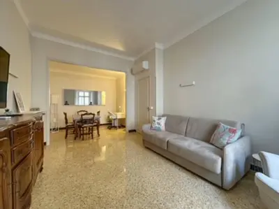 a living room with a couch and a table at Appartement central rue Hoche in Cannes