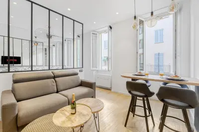 a living room with a couch and a table at 1 Chambre Modern L- Calme - Hypercentre à 2 minutes du Palais in Cannes
