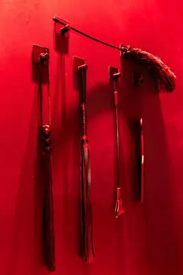 three red umbrellas hanging on a red wall at Évasion intime : Love Room de luxe à Cannes in Cannes