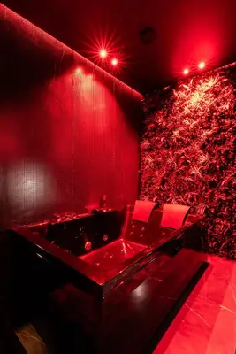 a red room with a bath tub with red lights at Évasion intime : Love Room de luxe à Cannes in Cannes