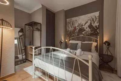 a bedroom with a bed with a painting on the wall at 