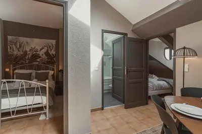 a room with a bed and a room with a dining table at 