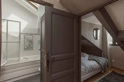a bedroom with a bed and a bath tub next to a window at 