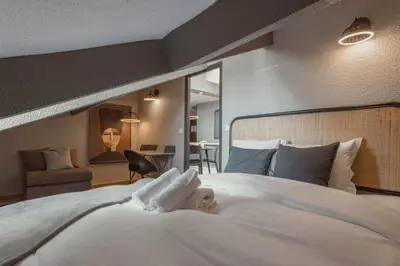 a child laying on a bed in a hotel room at 