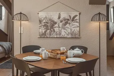 a dining room table with a basket of food on it at 