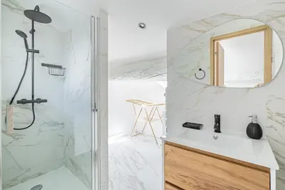 a bathroom with a shower and a sink with a mirror at 15 RIOUFFE - Splendide appartement 6 couchages à 50m à pieds du Palais in Cannes
