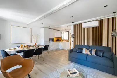 a living room with a blue couch and a table at 15 RIOUFFE - Splendide appartement 6 couchages à 50m à pieds du Palais in Cannes