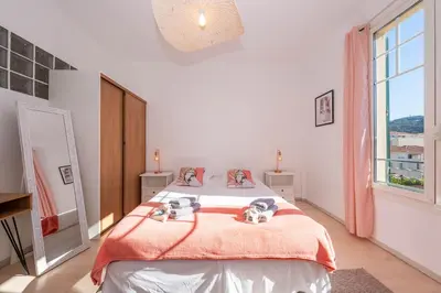 a bedroom with a bed and a large window at Cannes 3 BR 3 bath close to Palais & Croisette by Olam Properties in Cannes