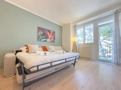 a bedroom with a bed and a large window at Le Palm by Winsome Destination in Cannes