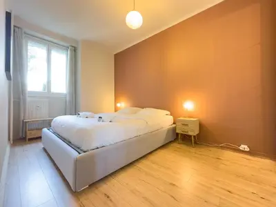a bedroom with a large bed and a window at Le Palm by Winsome Destination in Cannes