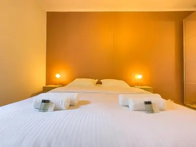 a bedroom with a large white bed with two lamps at Le Palm by Winsome Destination in Cannes