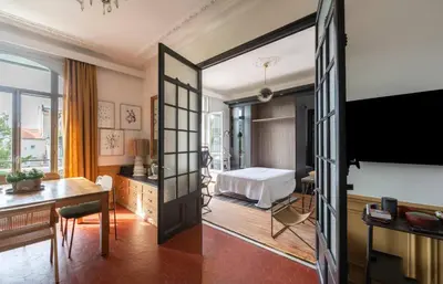 a hotel room with a bed and a desk at Magnifique 2 chambres Centre Cannes - 4 personnes - WIFI Terrasse in Cannes