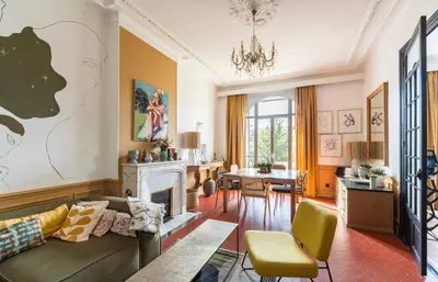 a living room with a couch and a fireplace at Magnifique 2 chambres Centre Cannes - 4 personnes - WIFI Terrasse in Cannes