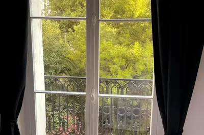 an open window with a view of a balcony at Augusta Palace - T3 **** 74m² - 150m Croisette in Cannes
