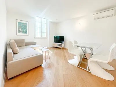 a large white bed in a room with a window at Tony Allard By Winsome Destination 3E in Cannes