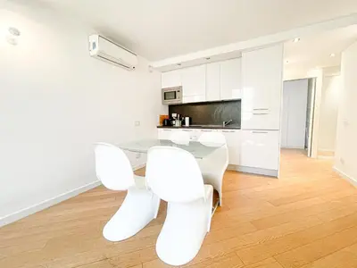 a kitchen with a glass table and white chairs at Tony Allard By Winsome Destination 3E in Cannes