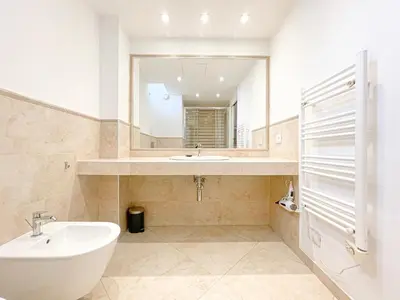 a white kitchen with a glass table and white chairs at Tony Allard By Winsome Destination 3E in Cannes