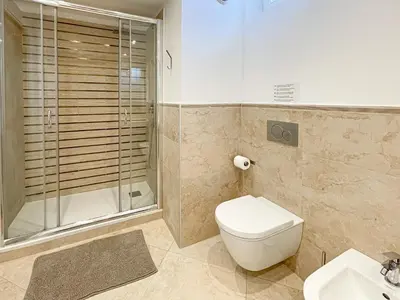 a bathroom with a toilet and a sink and a mirror at Tony Allard By Winsome Destination 3E in Cannes
