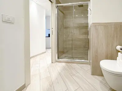 a bathroom with a shower and a toilet and a sink at Tony Allard By Winsome Destination 2E in Cannes