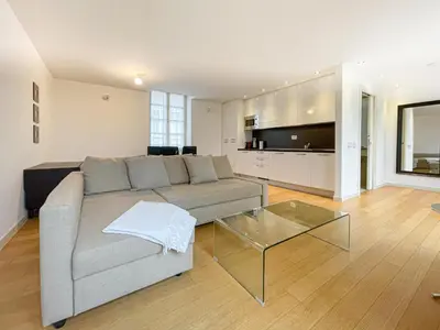 a bedroom with a large bed with an umbrella painting on the wall at Tony Allard By Winsome Destination 3D in Cannes