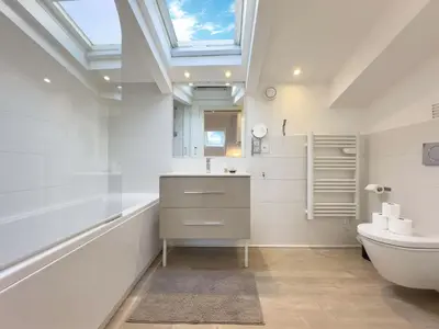 a white bedroom with a bed and a skylight at Tony Allard By Winsome Destination 4B in Cannes