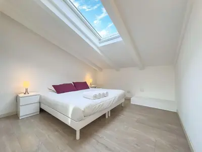 a kitchen with white cabinets and a skylight at Tony Allard By Winsome Destination 4B in Cannes